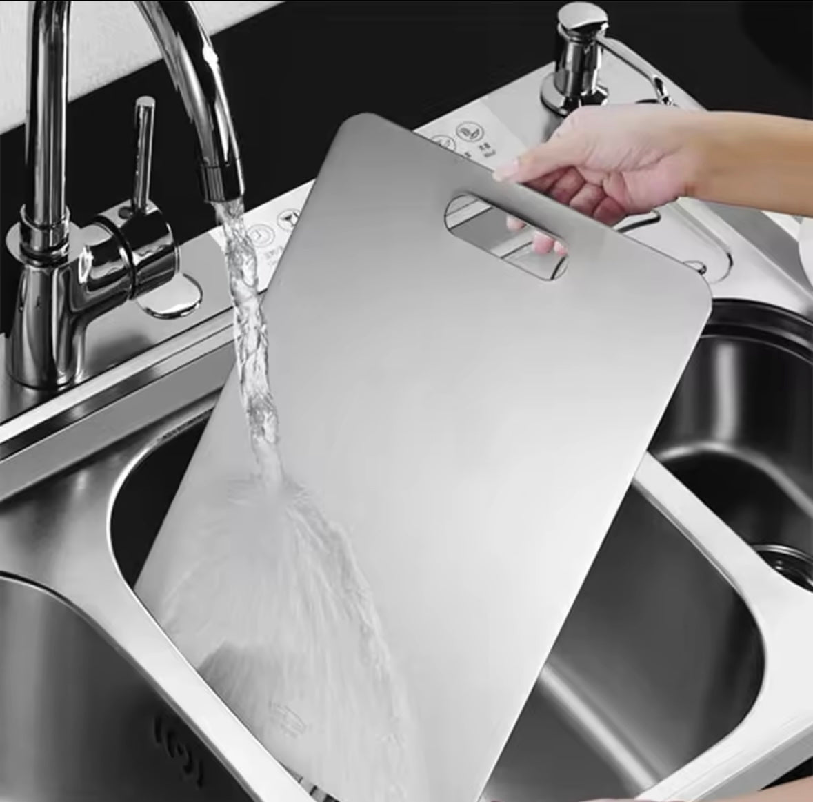 Rose and Teddy Stainless Steel cutting board being cleaned in sink